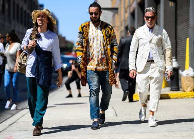 Three men wearing unique fashion styles outdoors.