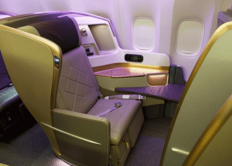 Singapore Airlines' first-class seat: plush, spacious, luxurious amenities.