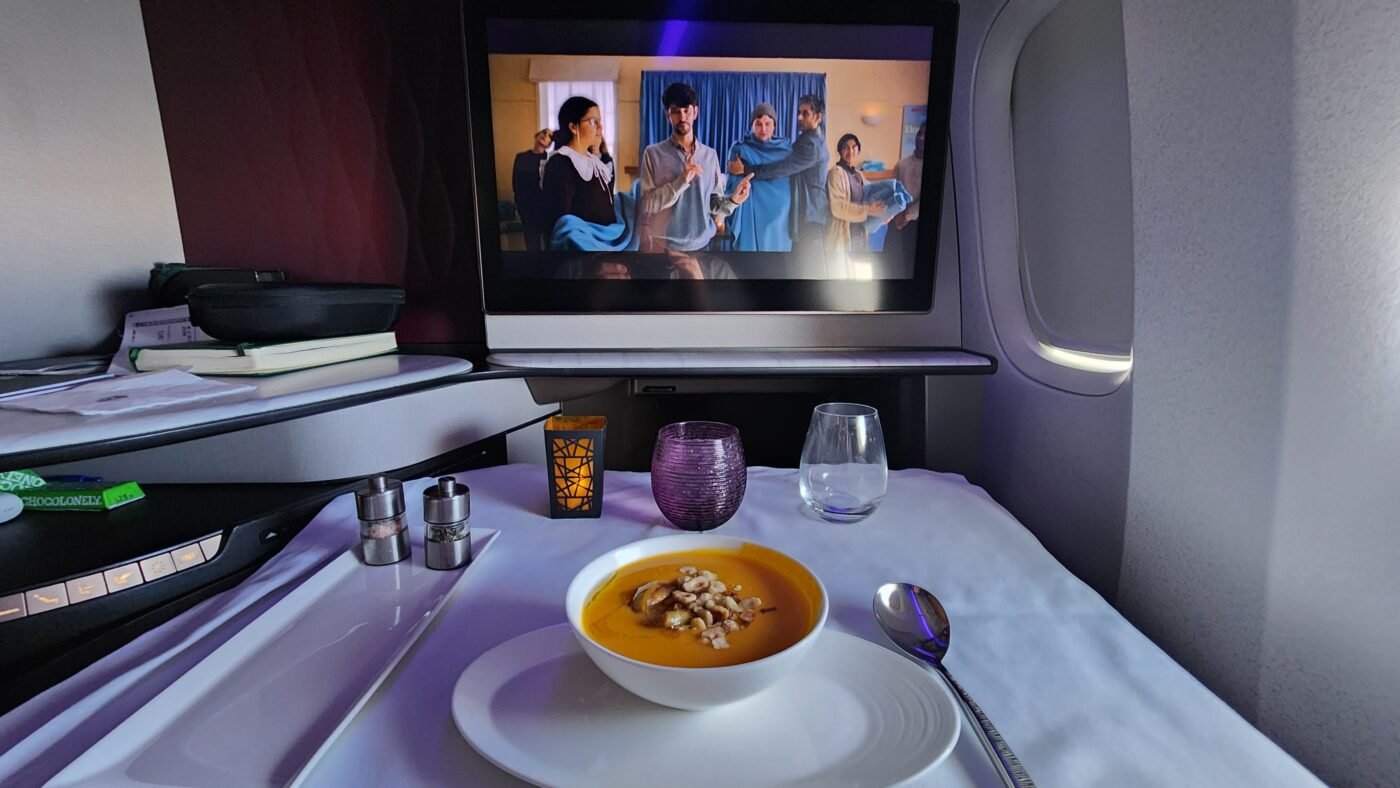 Soup with garnishes served in Qatar QSuite business class.