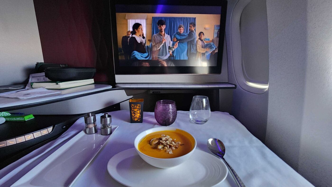 Qatar Business Class: soup, spoon, and movie await.