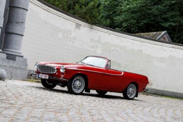 Vintage Roadster parked on street.