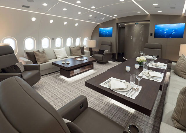 Boeing 787 Business Jet interior: luxurious seating, dining area.