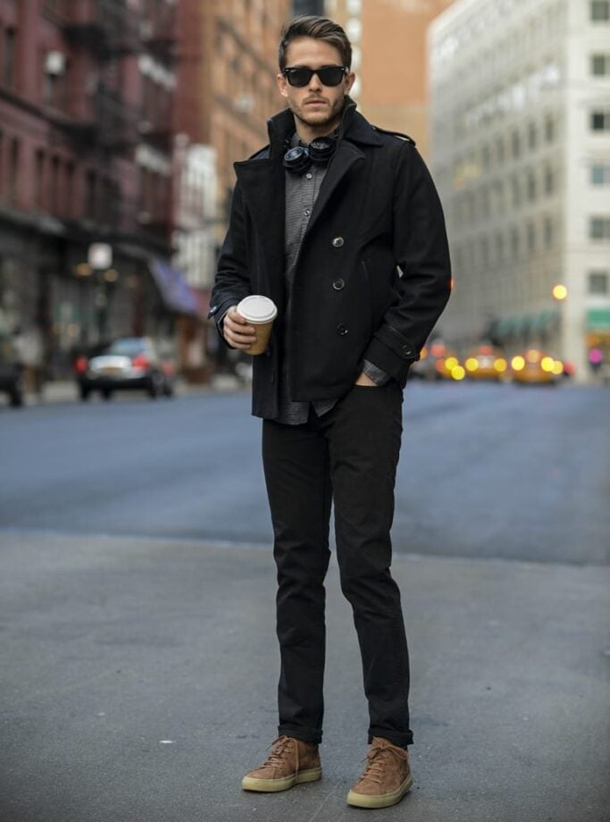 Man with coffee on street.