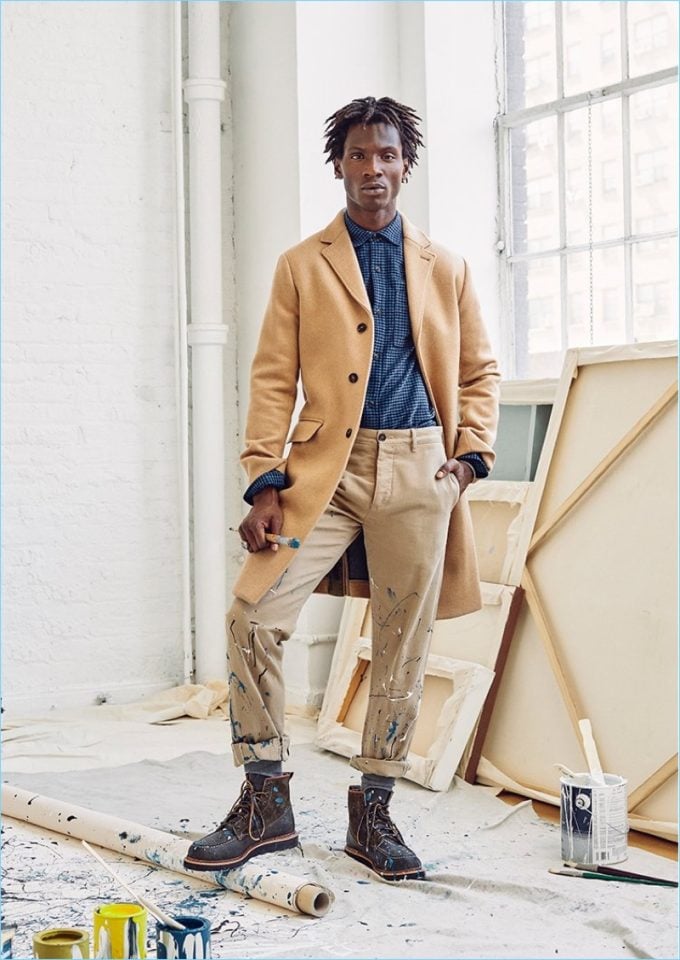 A model wearing long coat and stylish pants combined with boots