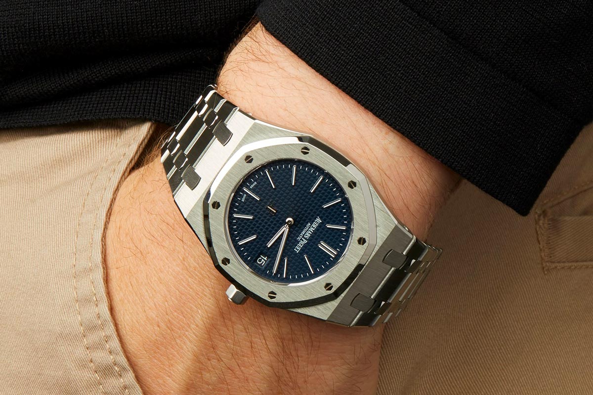 Wrist with Audemars Piguet Royal Oak watch.