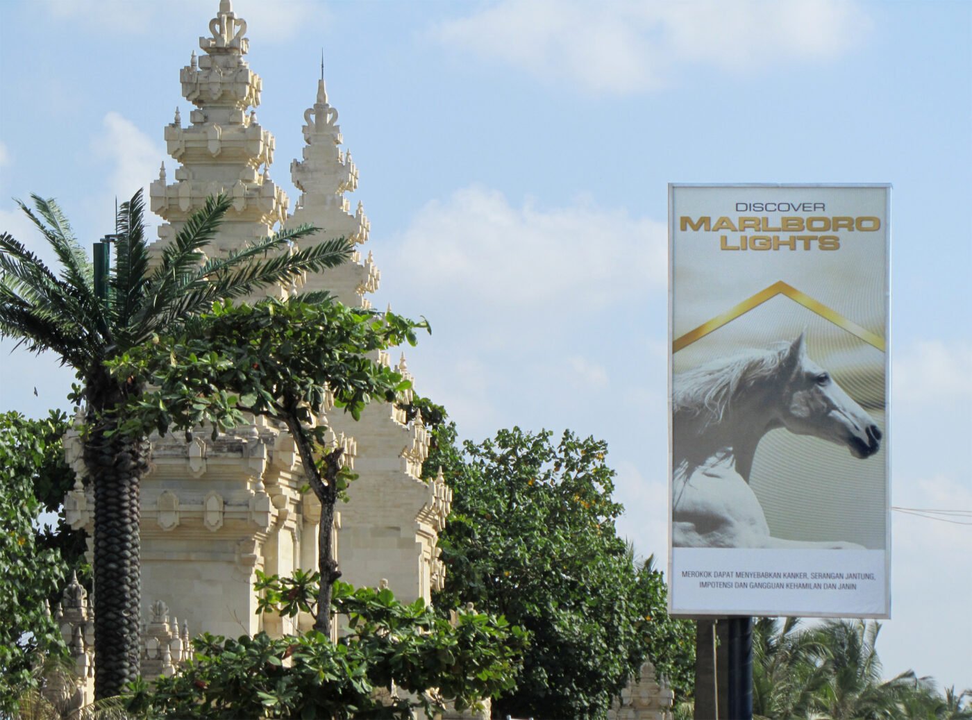 An Indonesian temple near Marlboro Lights billboard.