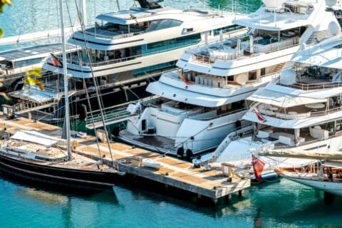 Superyachts docked at Bali marina on sunny day.