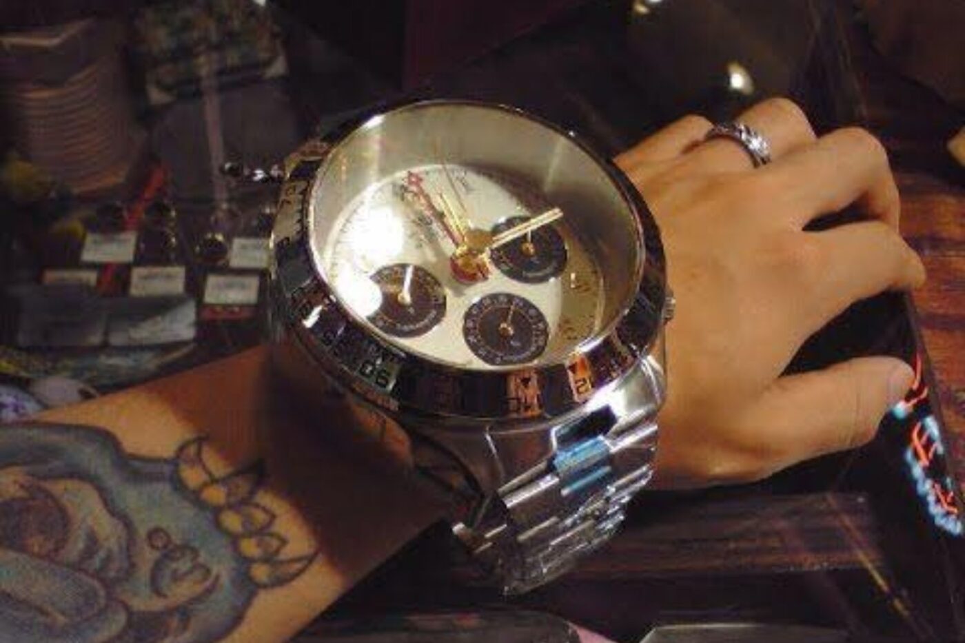 First watch: silver band, tattoo.