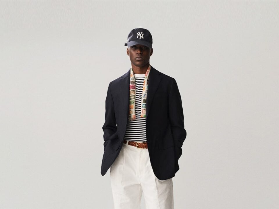 Man wearing black blazer on top of striped tee