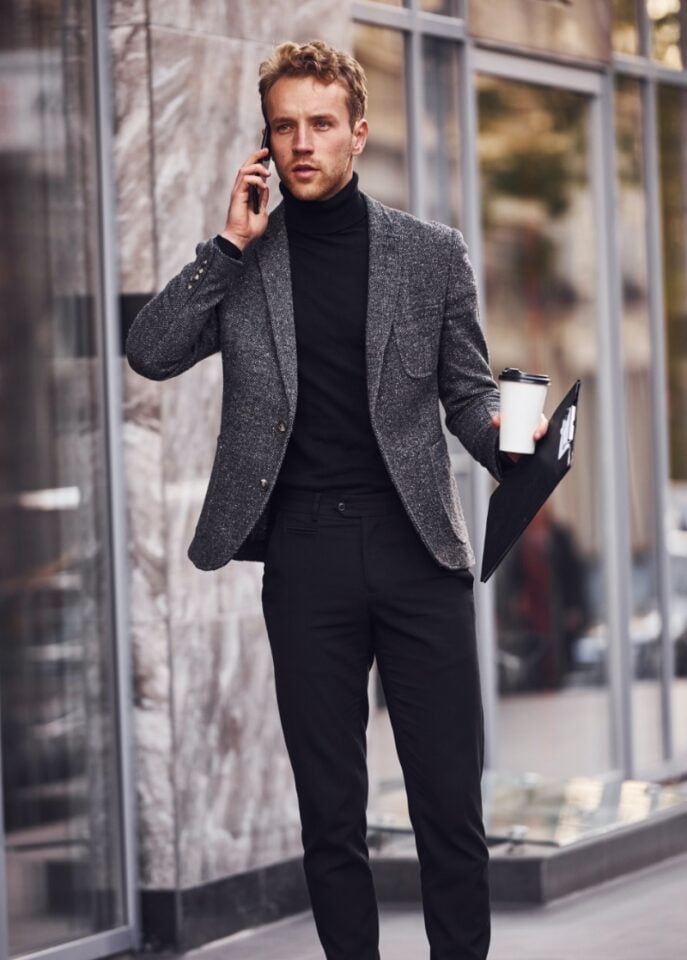 A man on his smart casual attire wearing turtleneck with blazer