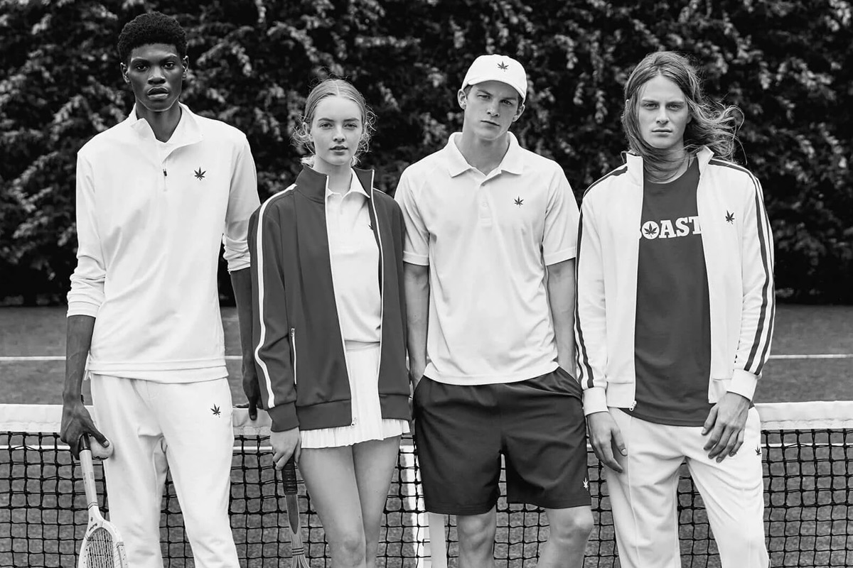 Four people posing in tenniswear.