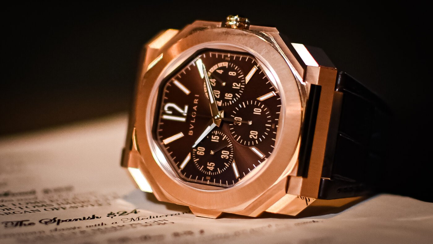 Gold luxury watch with chronograph on book.