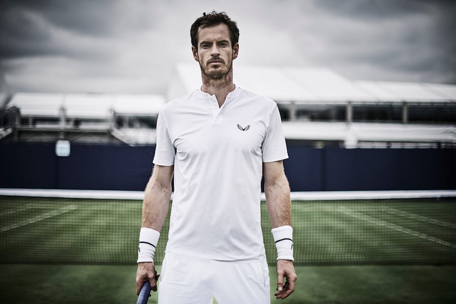 Player holds racket on court.