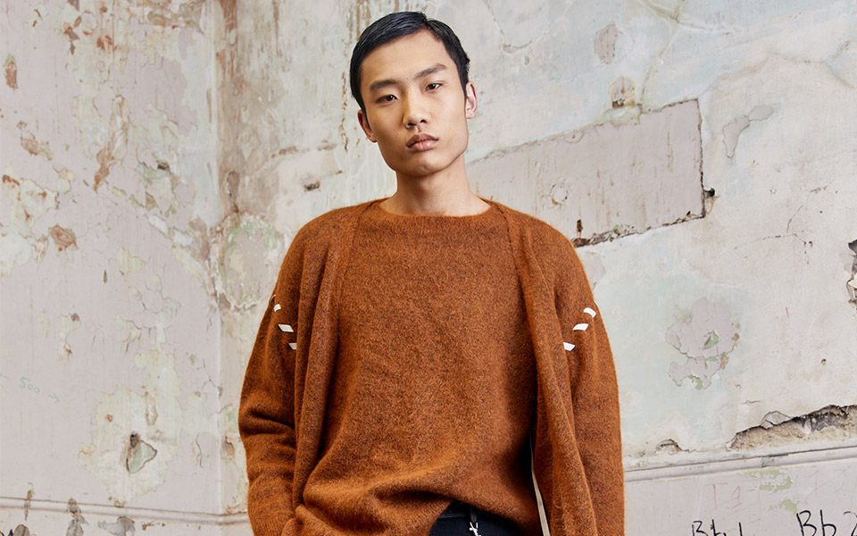 Person in brown sweater from Australian brand.