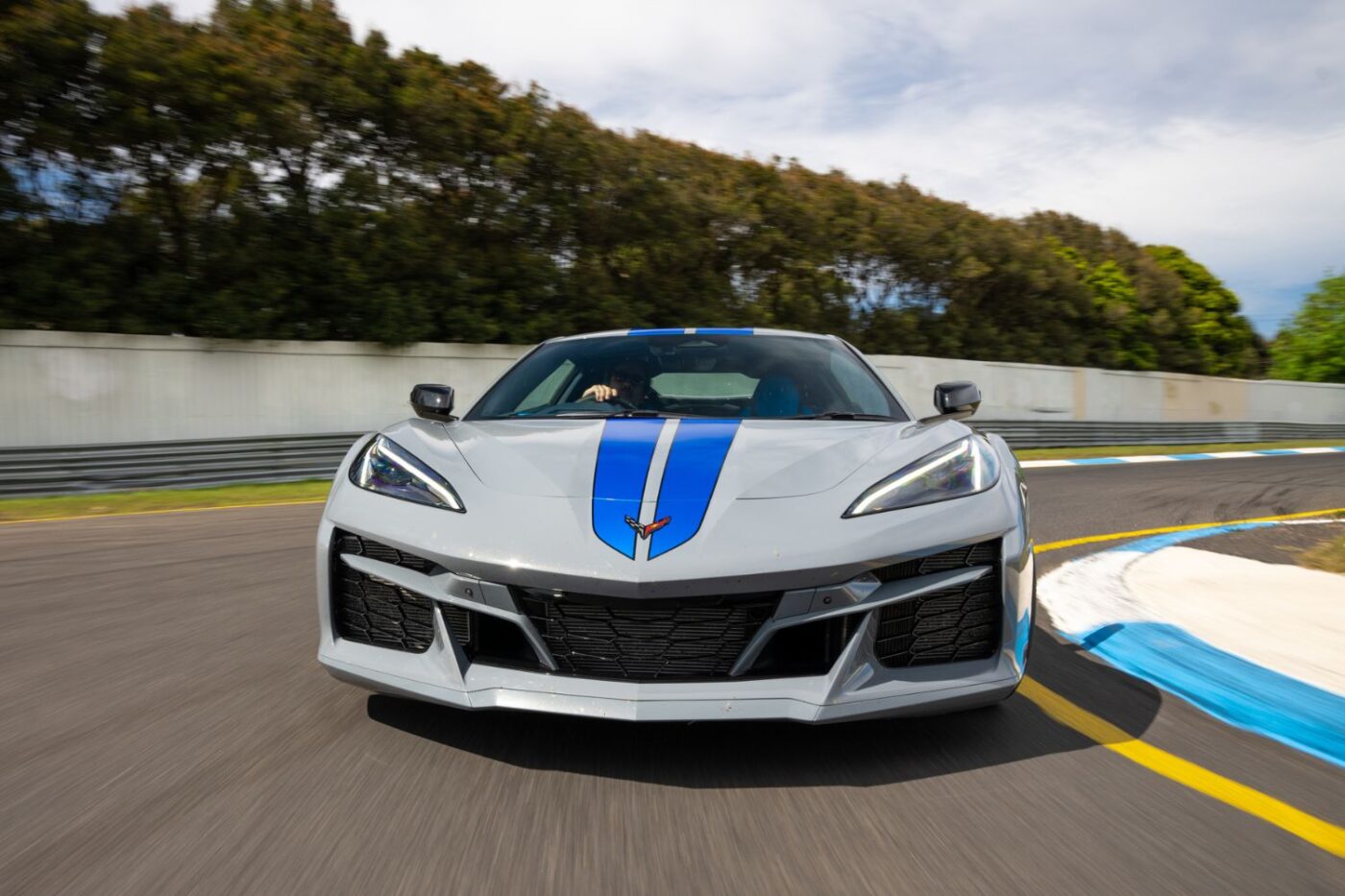 A silver Corvette races on Melbourne track.