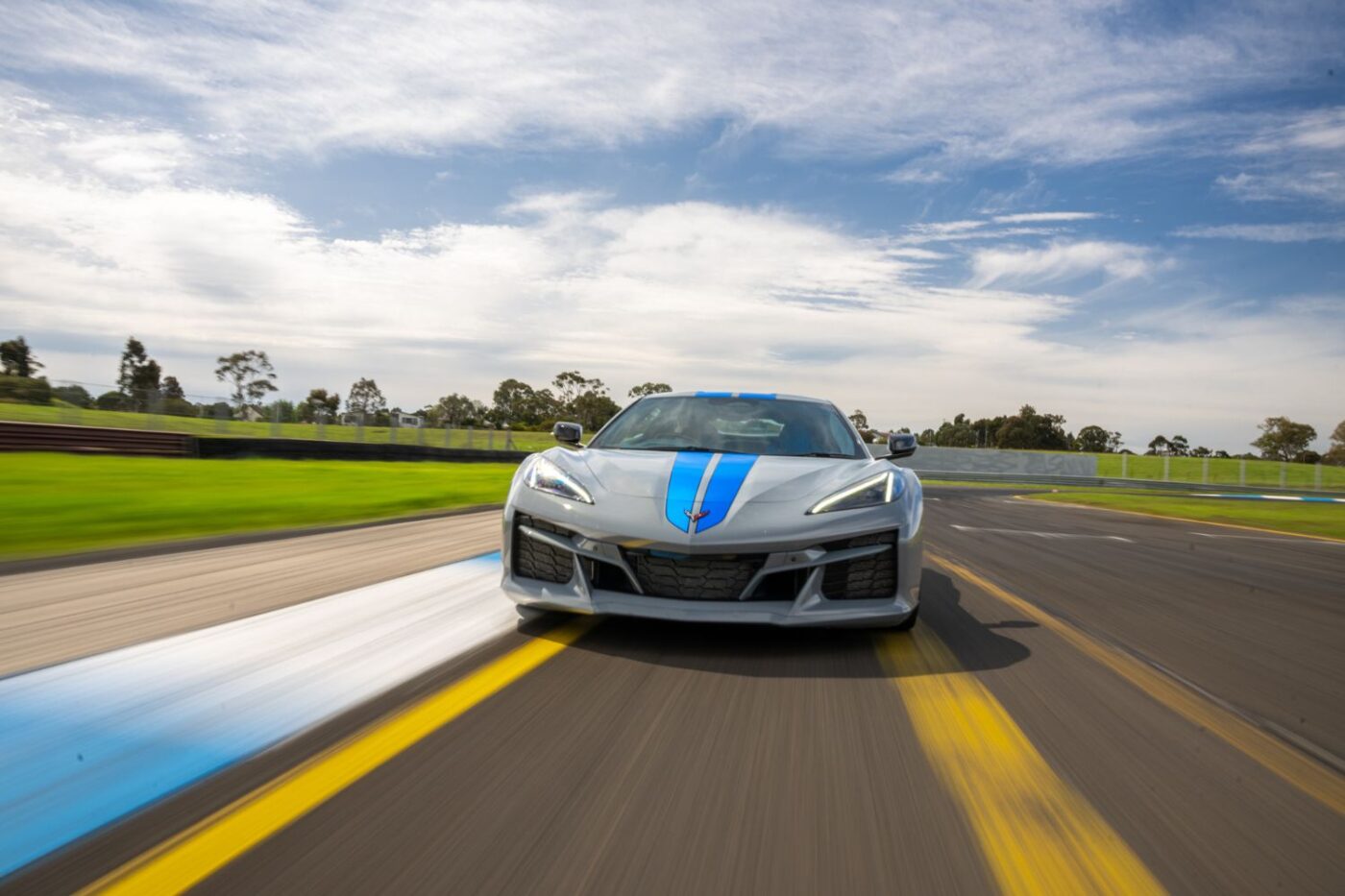 Silver Corvette speeds down Melbourne track.