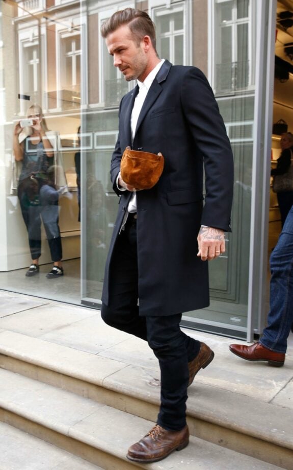 Man with bag walking outdoors.