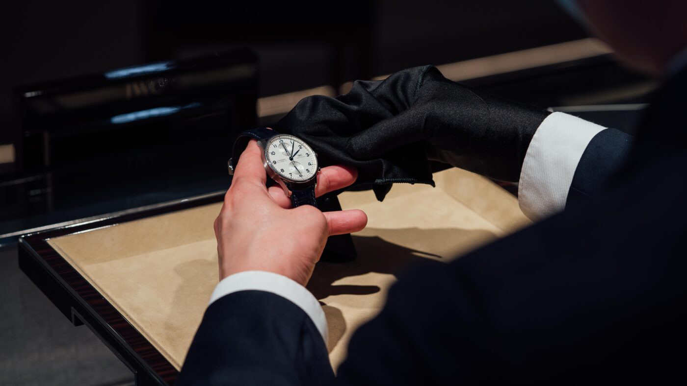 A person holds an elegant IWC luxury watch.