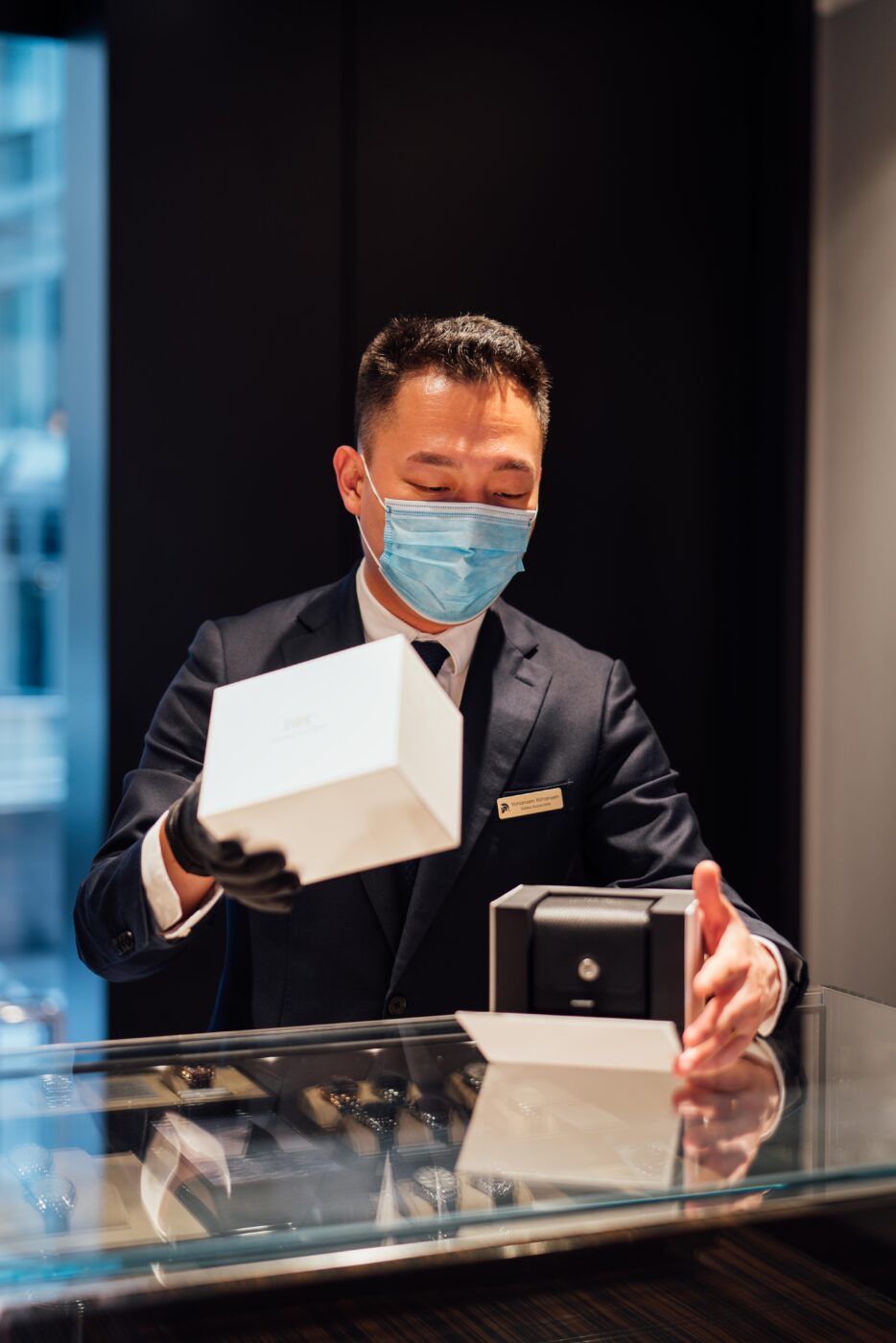 Salesperson unveils IWC box in Sydney store.