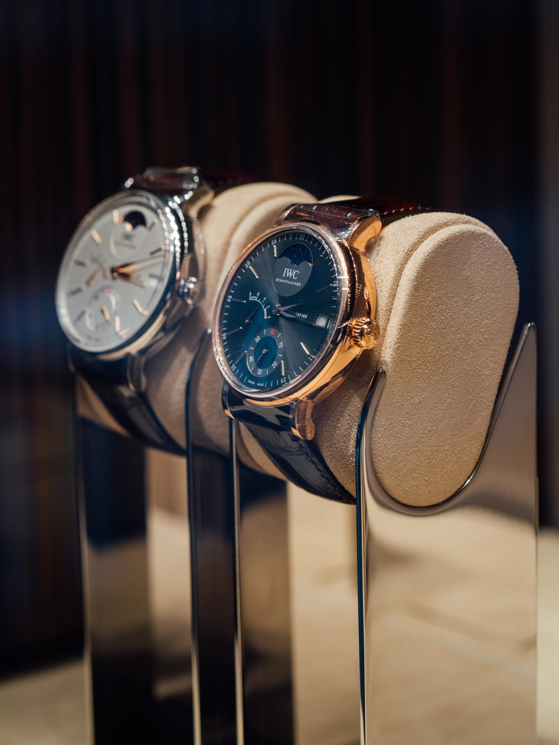 Luxury watches displayed: silver face, gold case.