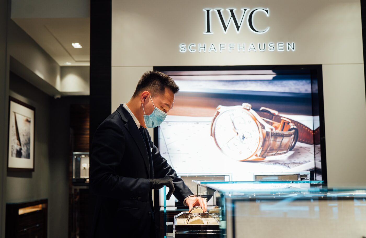 Man inspects watches at IWC Schaffhausen store.