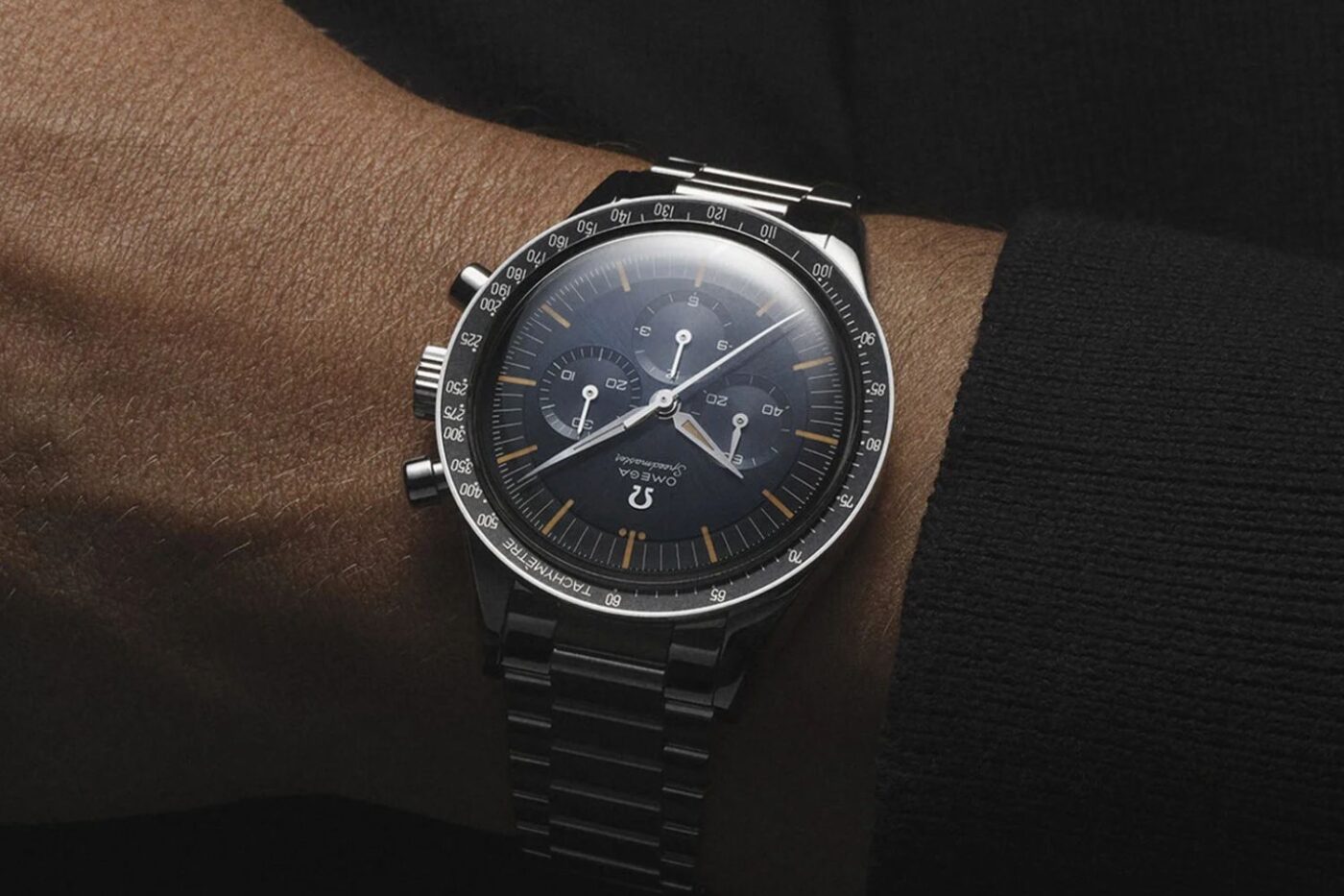 OMEGA chronograph watch on wrist, vintage style.