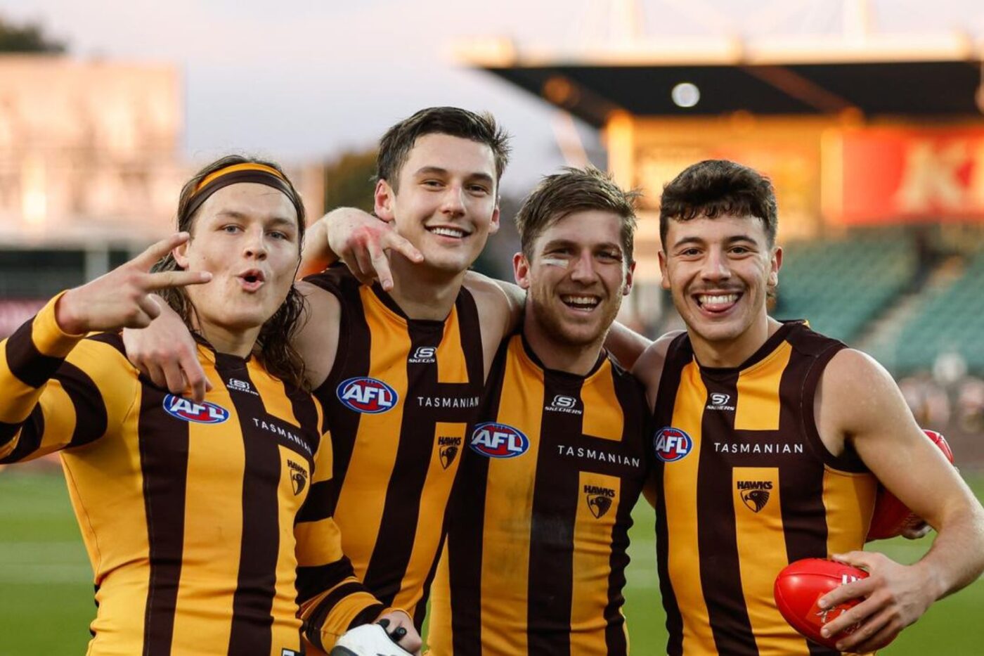 Football players smile at stadium.