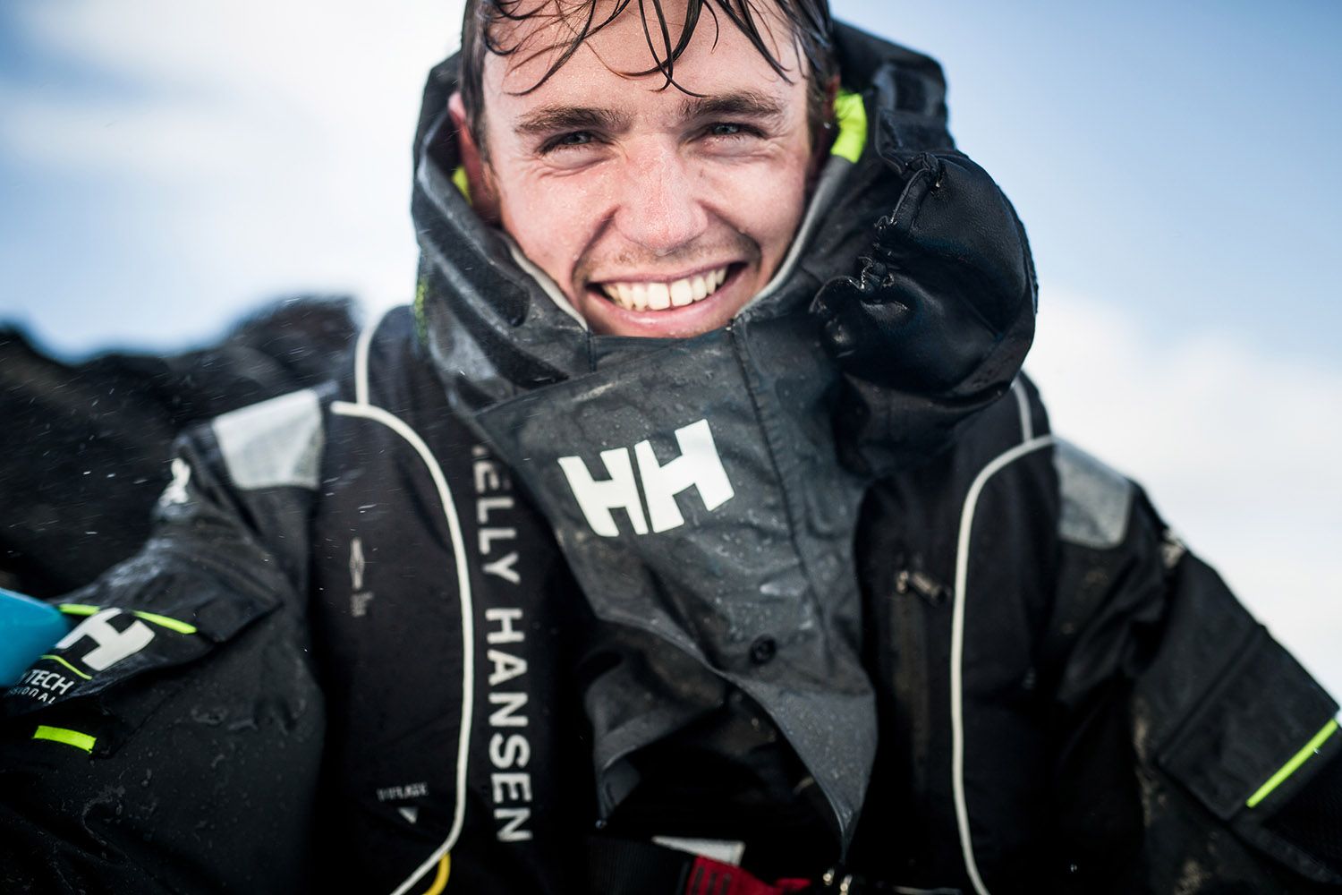 Smiling in Helly Hansen outdoors.