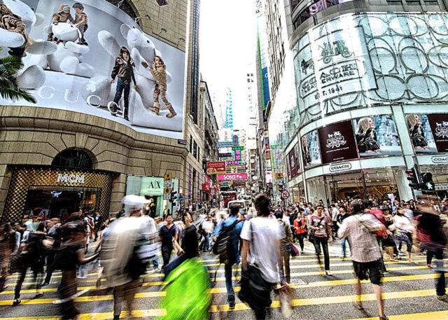 Hong Kong's lively street scene with Gucci ads.