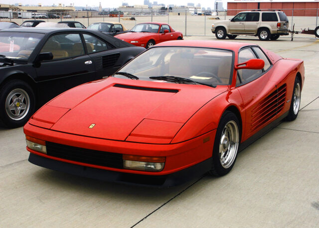 A red sports car parked by skyline.