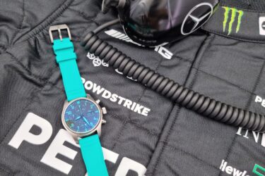 Teal Pilot's Watch and helmet with Mercedes suit.