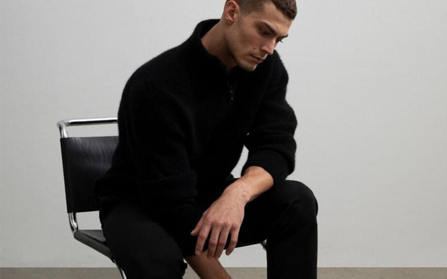 Person in sleek Australian menswear, looking contemplative.