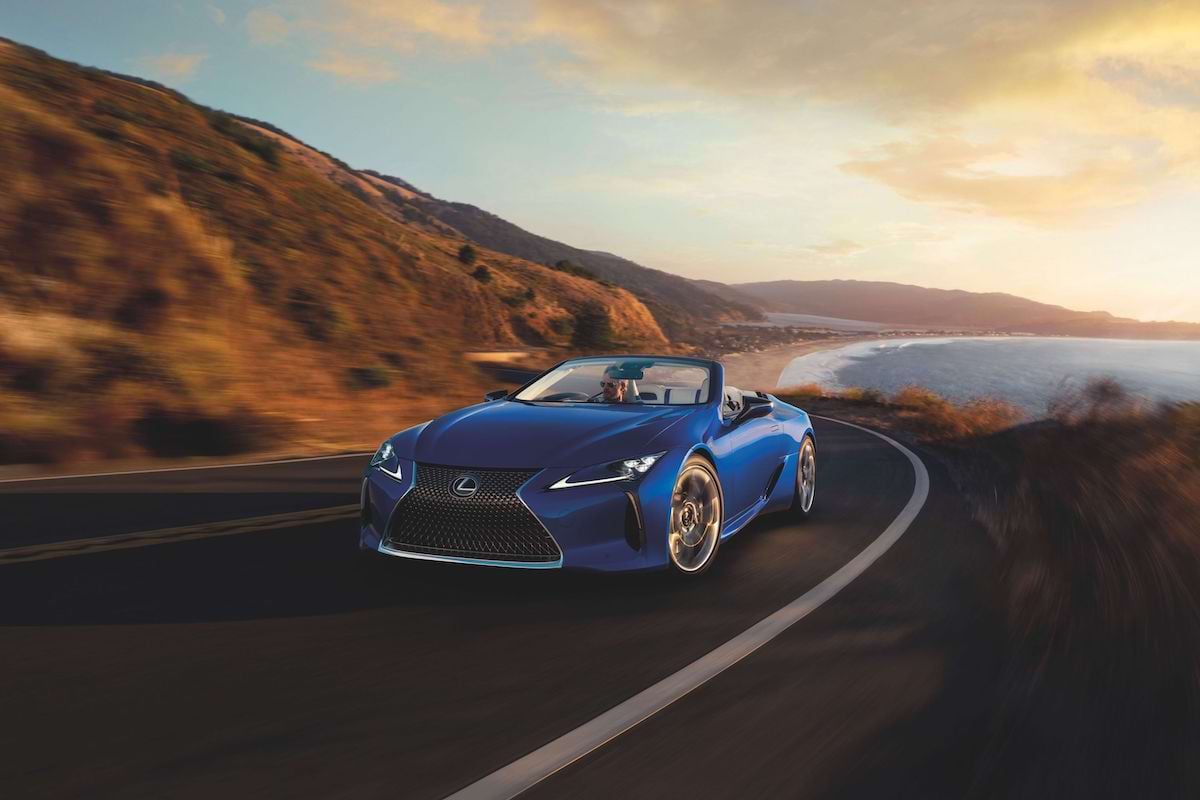 A premium Australian convertible drives along the coast.