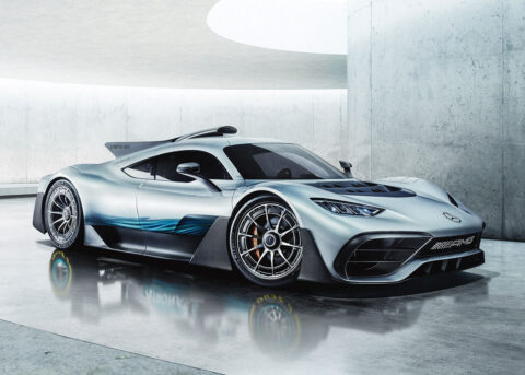 Silver Mercedes sports car indoors against concrete backdrop.