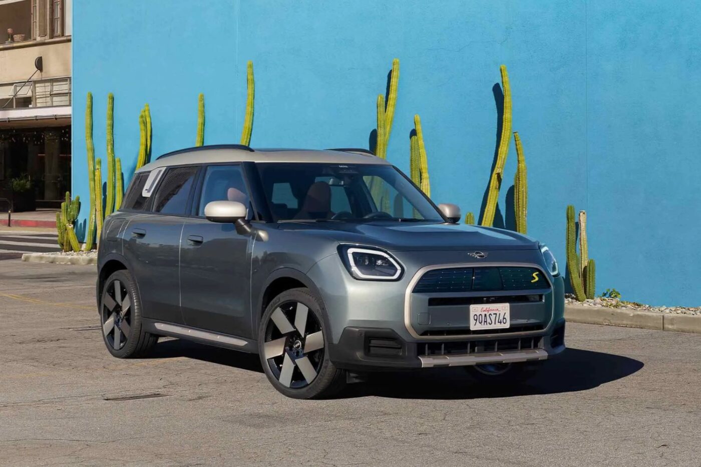 MINI Countryman SUV parked by blue wall.