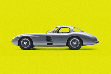 Silver Mercedes-Benz sports car on yellow background.