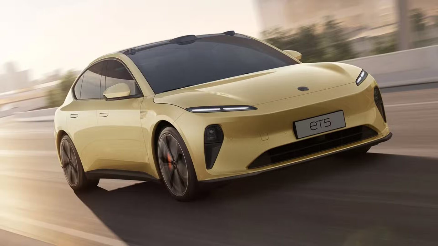 Yellow electric car on sunny Australian highway.