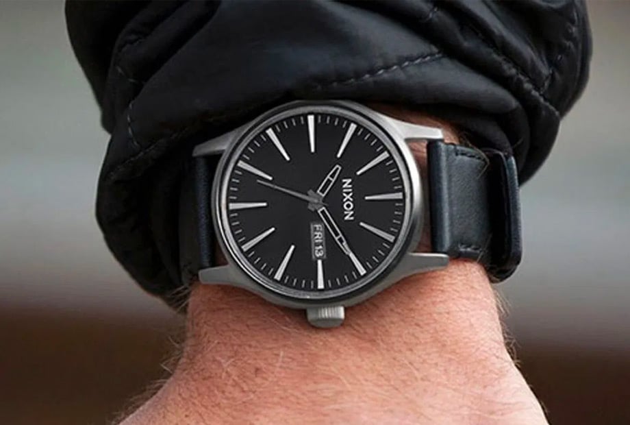 Nixon watch on black jacket.