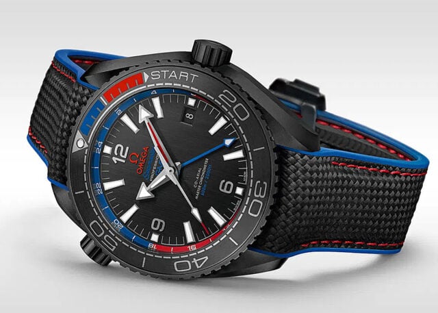 Omega wristwatch: Black-blue design, vivid red detailing.