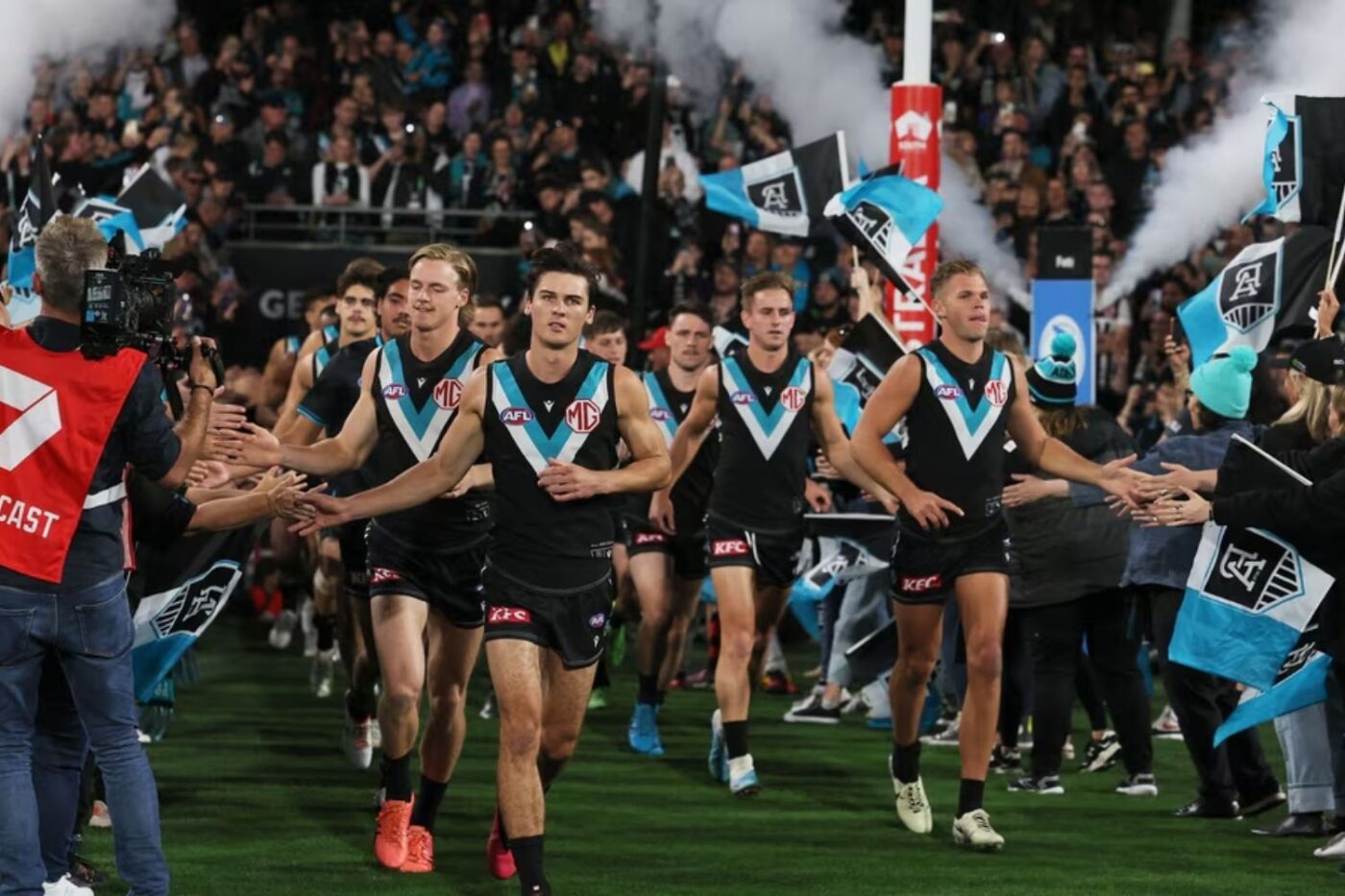 Australian football team enters field.