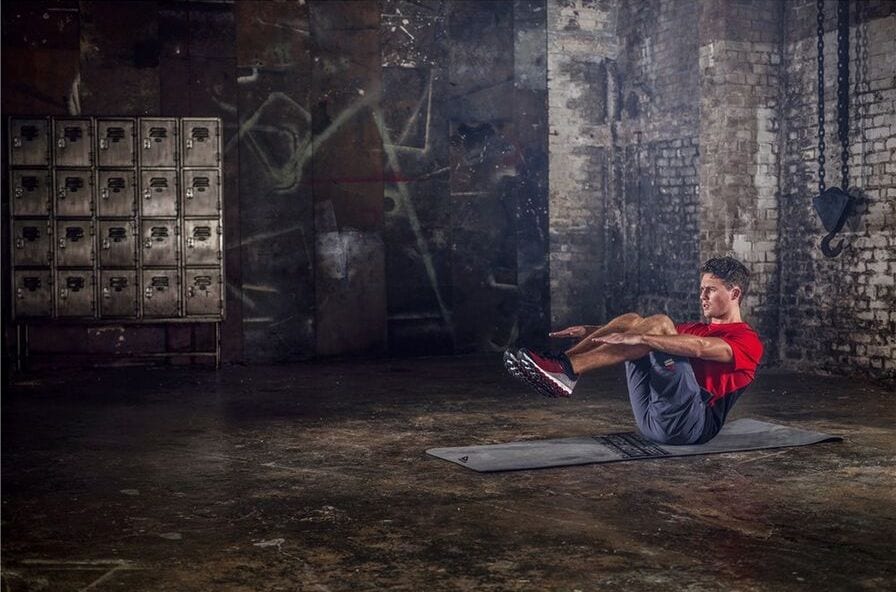 Red-shirted athlete in rustic gym.