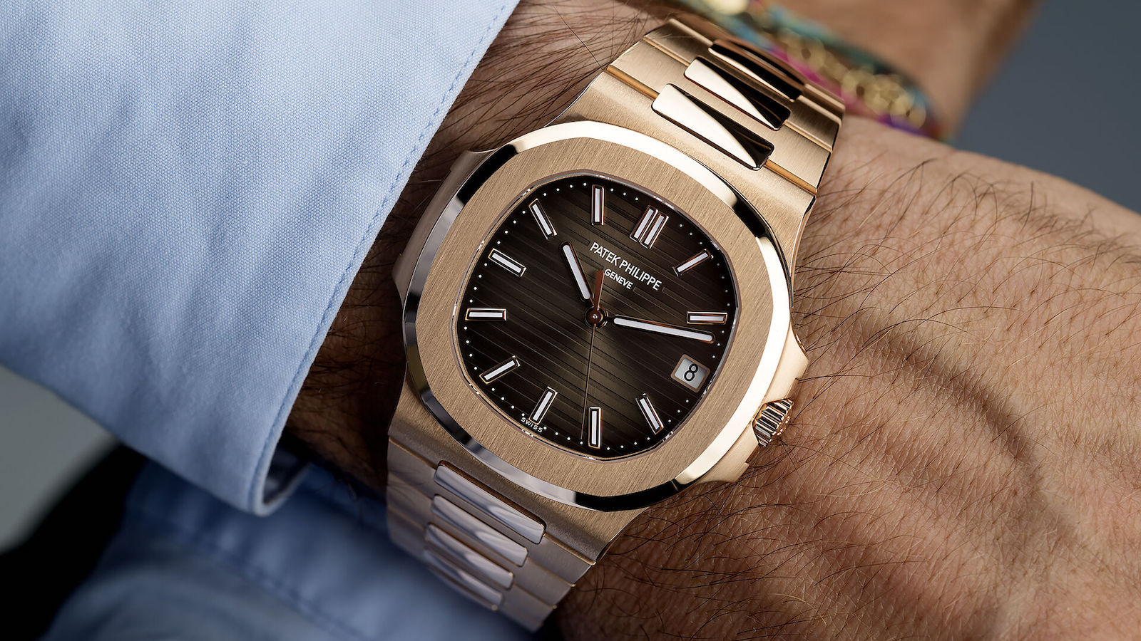 Wrist displays rose gold luxury watch.