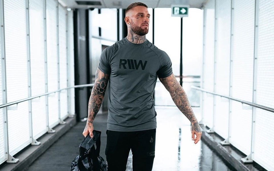 Tattooed man in RIW shirt.