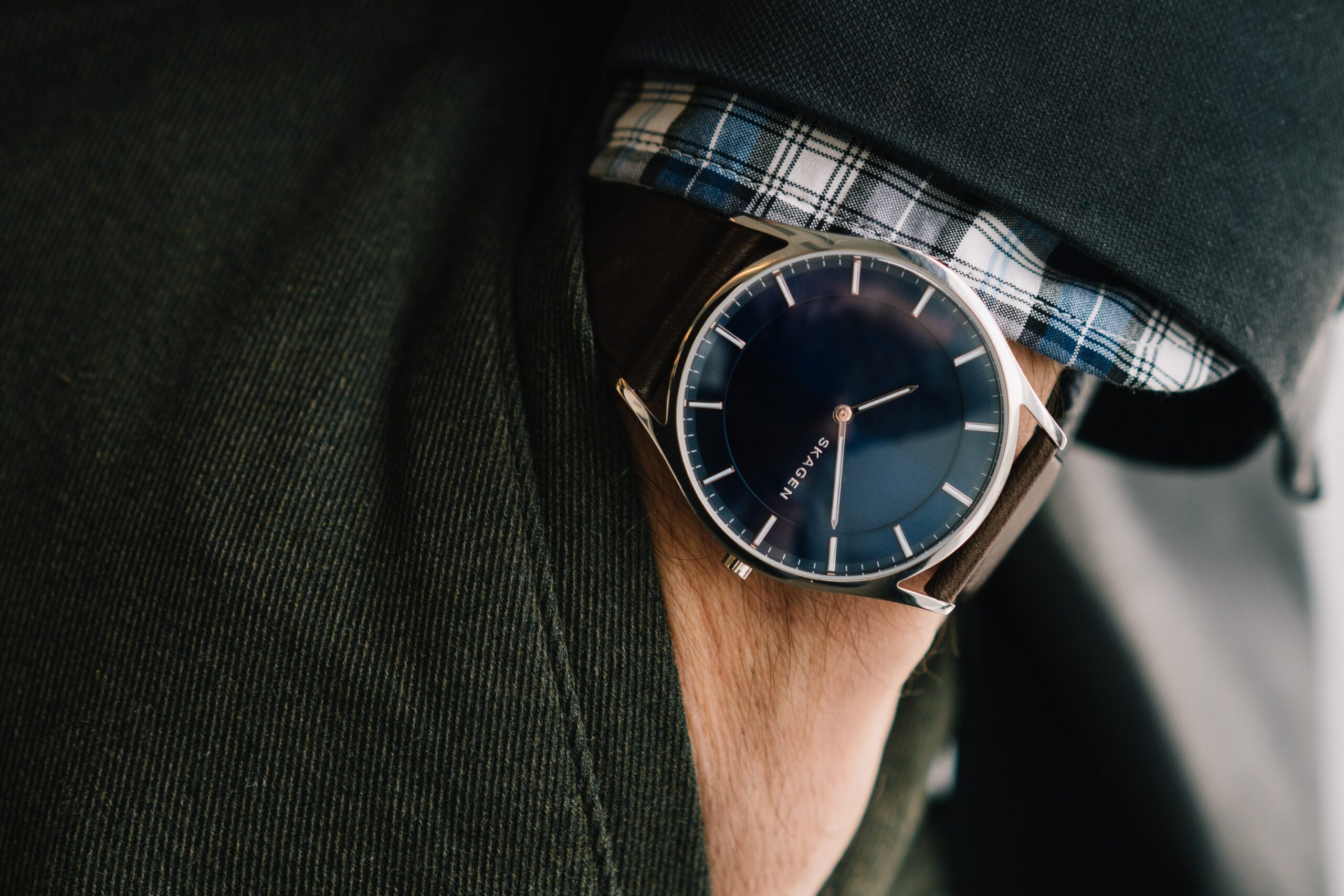 Plaid shirt, jacket, minimalist watch.