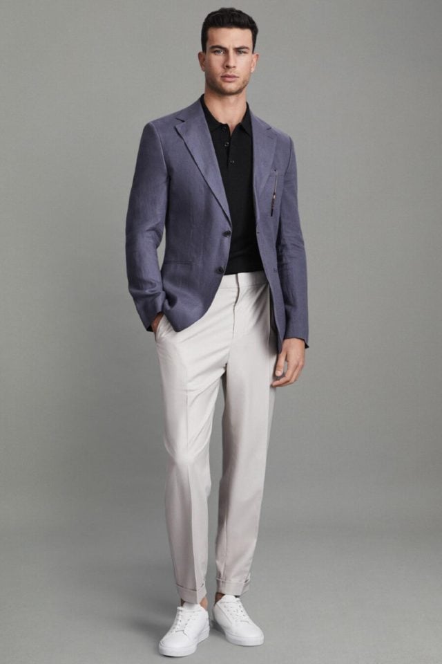 A model wearing business casual attire, a mix of polo, blazer, and chino