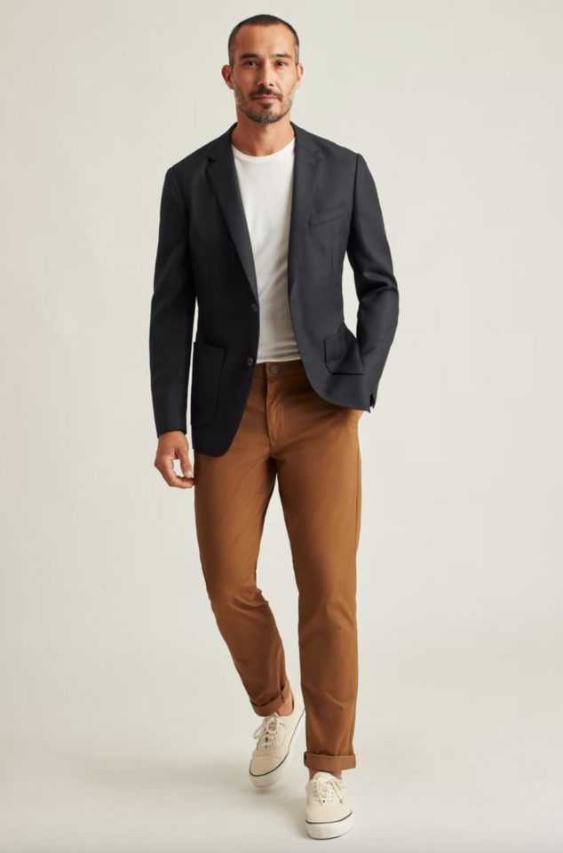 A model wearing white tee tucked into brown chino