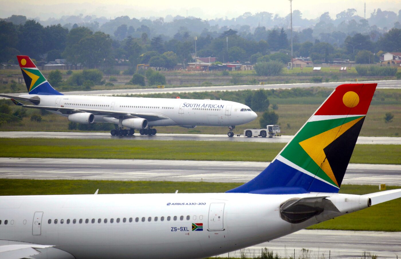 South African Airways planes, airport background.