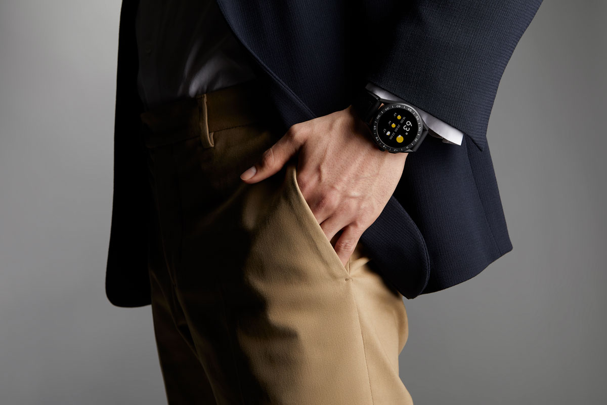 TAG Heuer smartwatch, dark blazer.