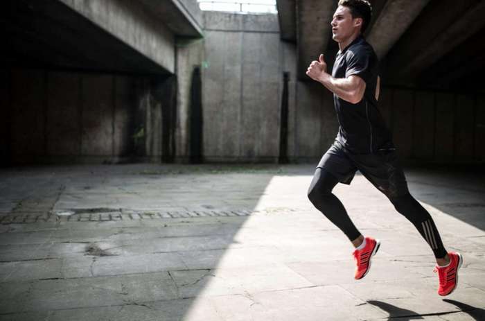 Nike runner in shadows underpass.