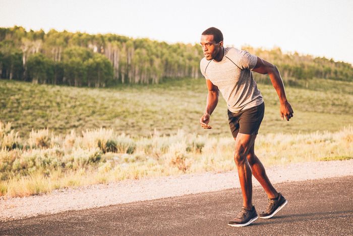 Man in Nike jogs at sunset.